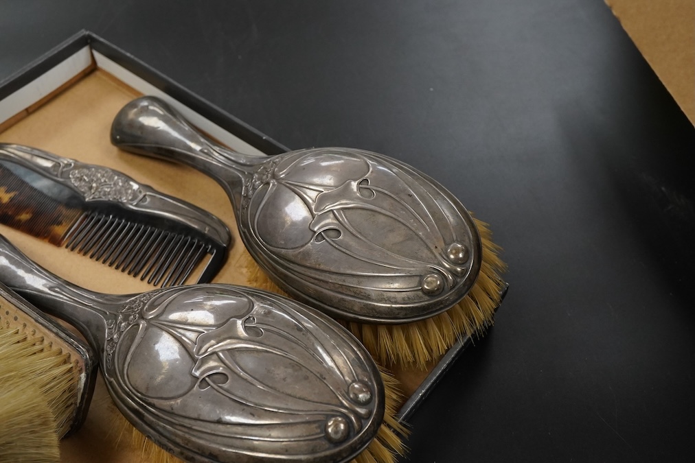 An Art Nouveau Hutton & Son silver mounted five piece dressing table set